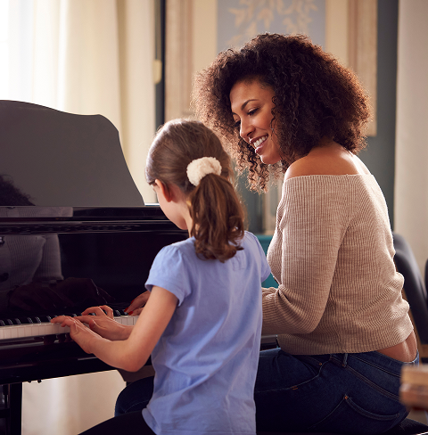 Piano lesson with woman and girl