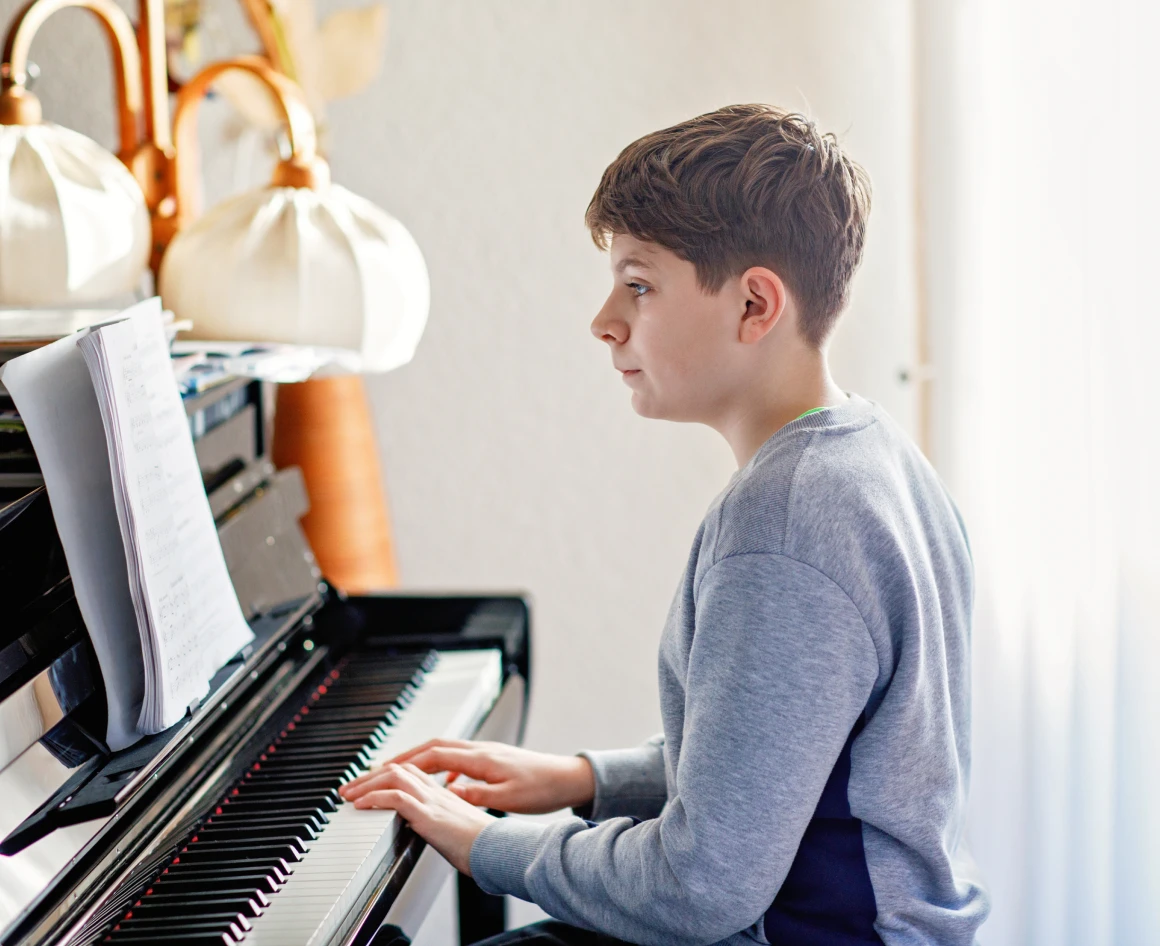 Teen focused on piano sheet music
