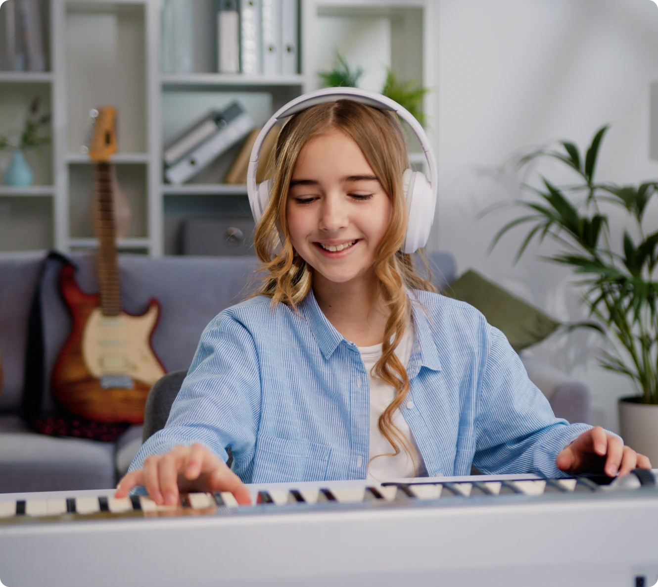 Girl playing keyboard with headphones