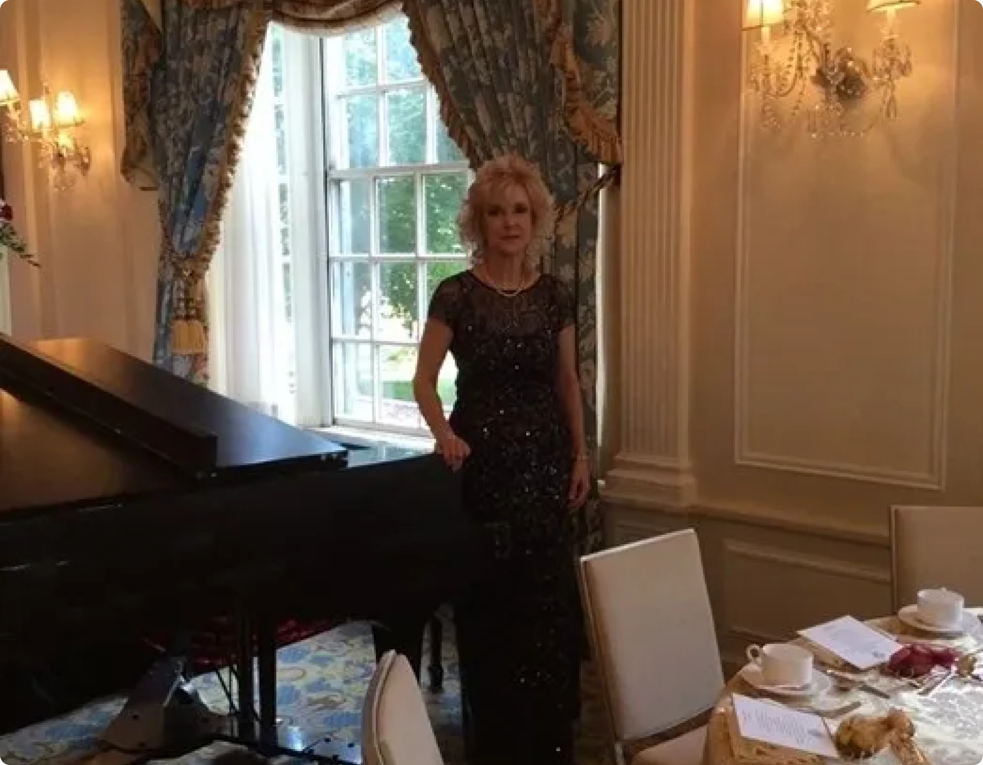 Woman in evening dress by piano